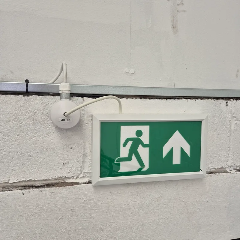 Emergency exit light wired from surface trunking