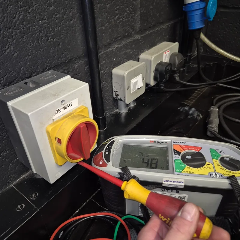 Electrical testing at a rotary isolator with a calibrated Megger tester