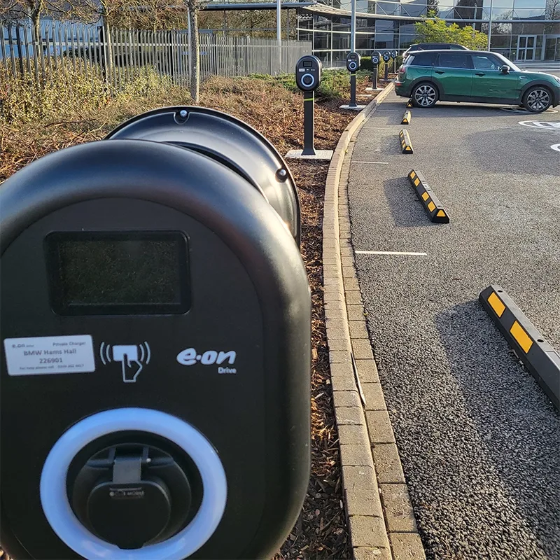 Row of EV pedestal chargers installed at a workplace car park