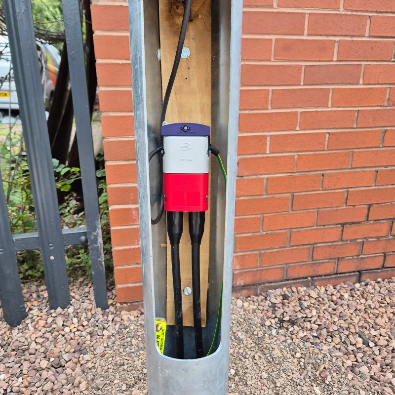 Base of a galvanised lighting column wired ready for commissioning
