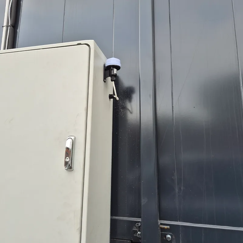 Weatherproof control cabinet with a dusk-to-dawn sensor installed outdoors